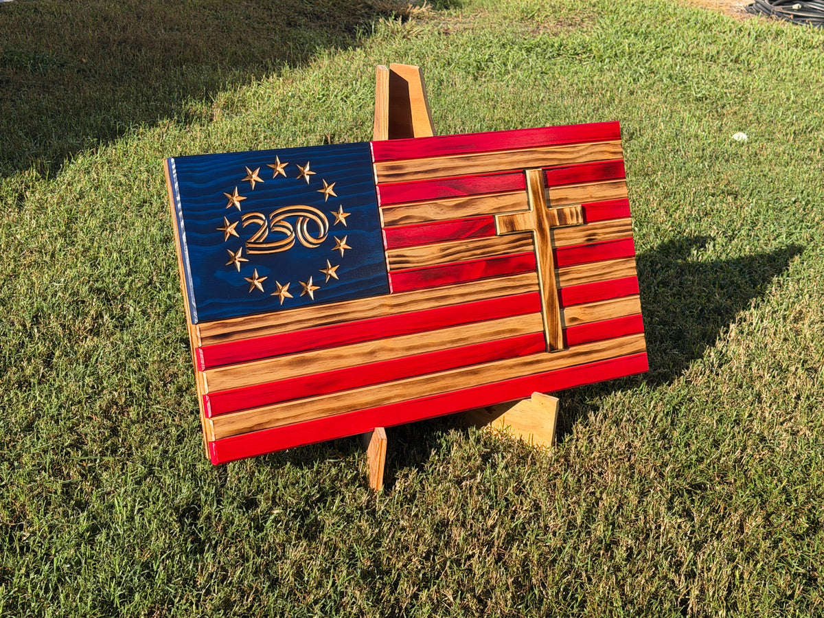 Angled view of red and natural wood-tone American flag with blue star field and wooden cross